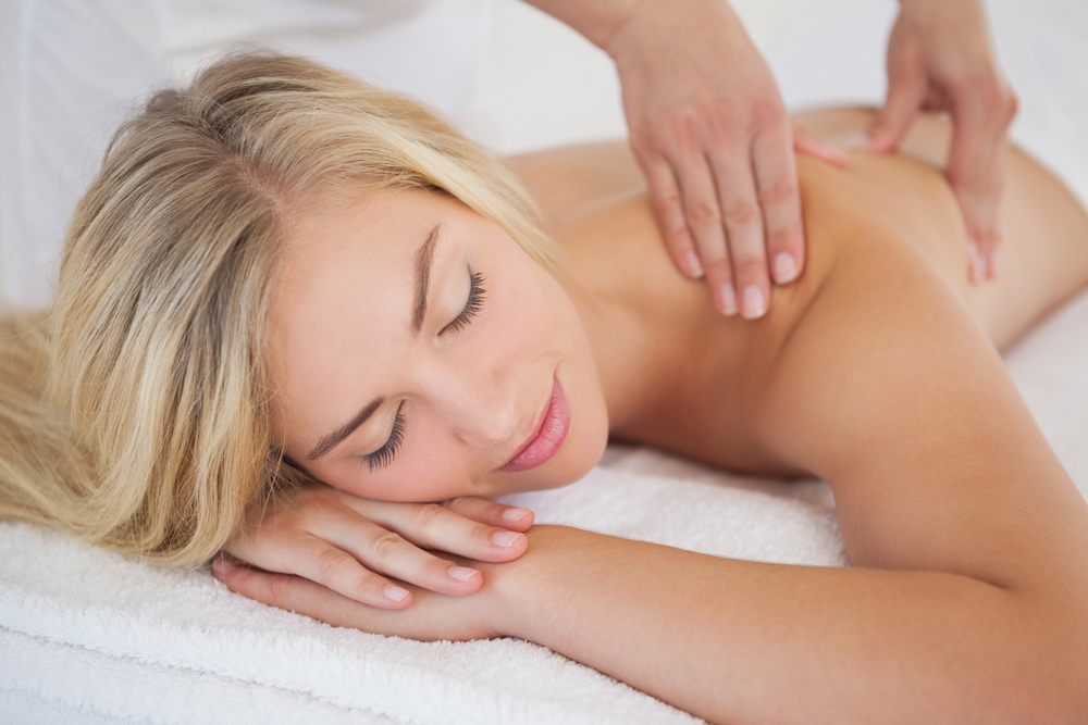 Woman relaxing during a shoulder massage at a spa