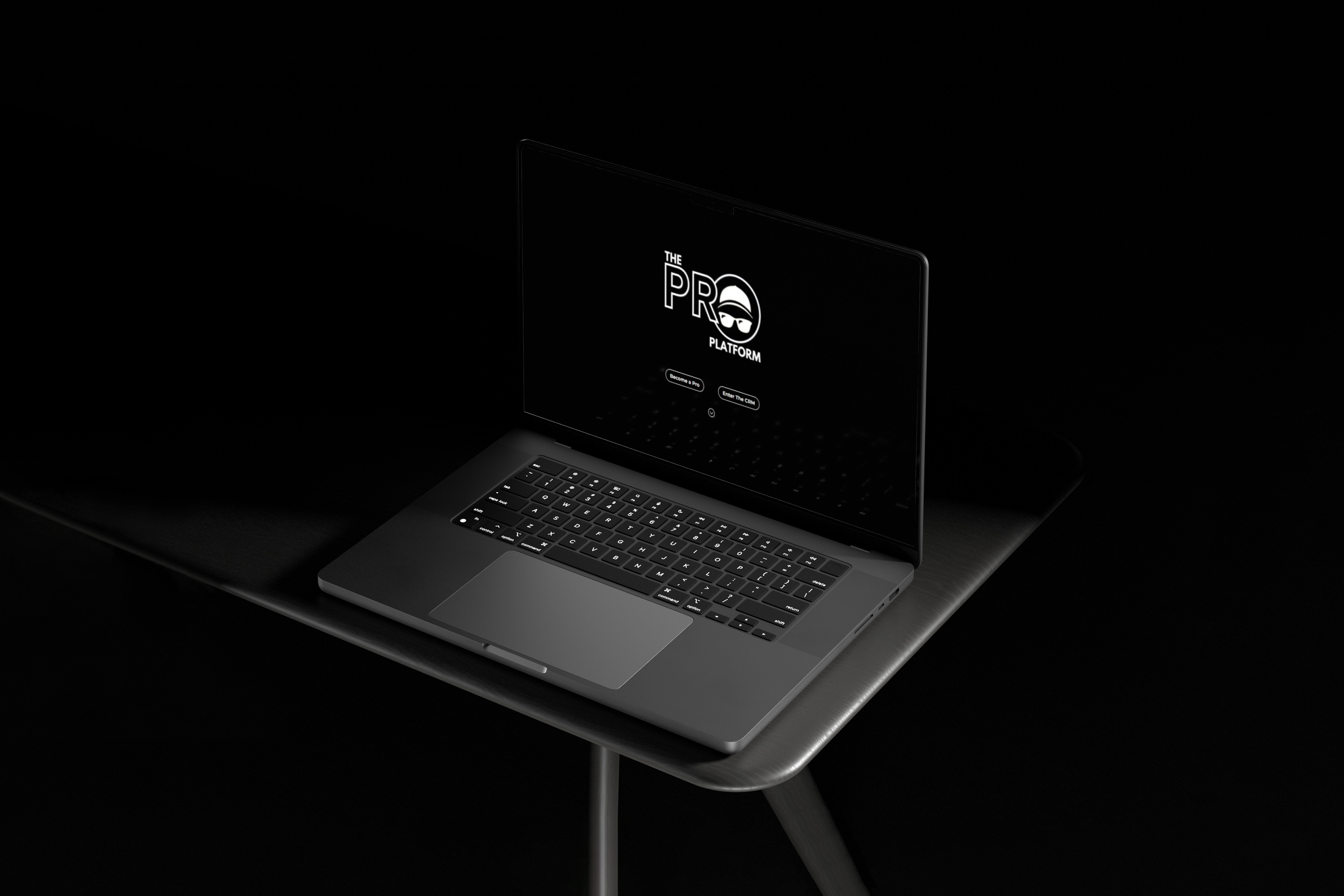 A black laptop on a table in a dark room.
