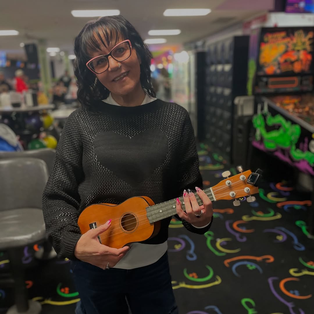 woman holding ukelele