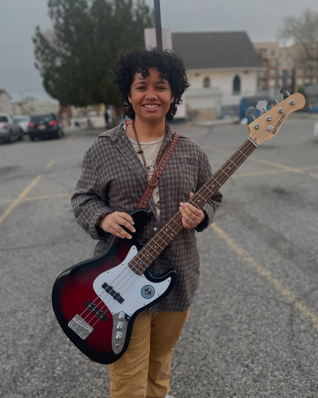 young woman holding a bass guitar