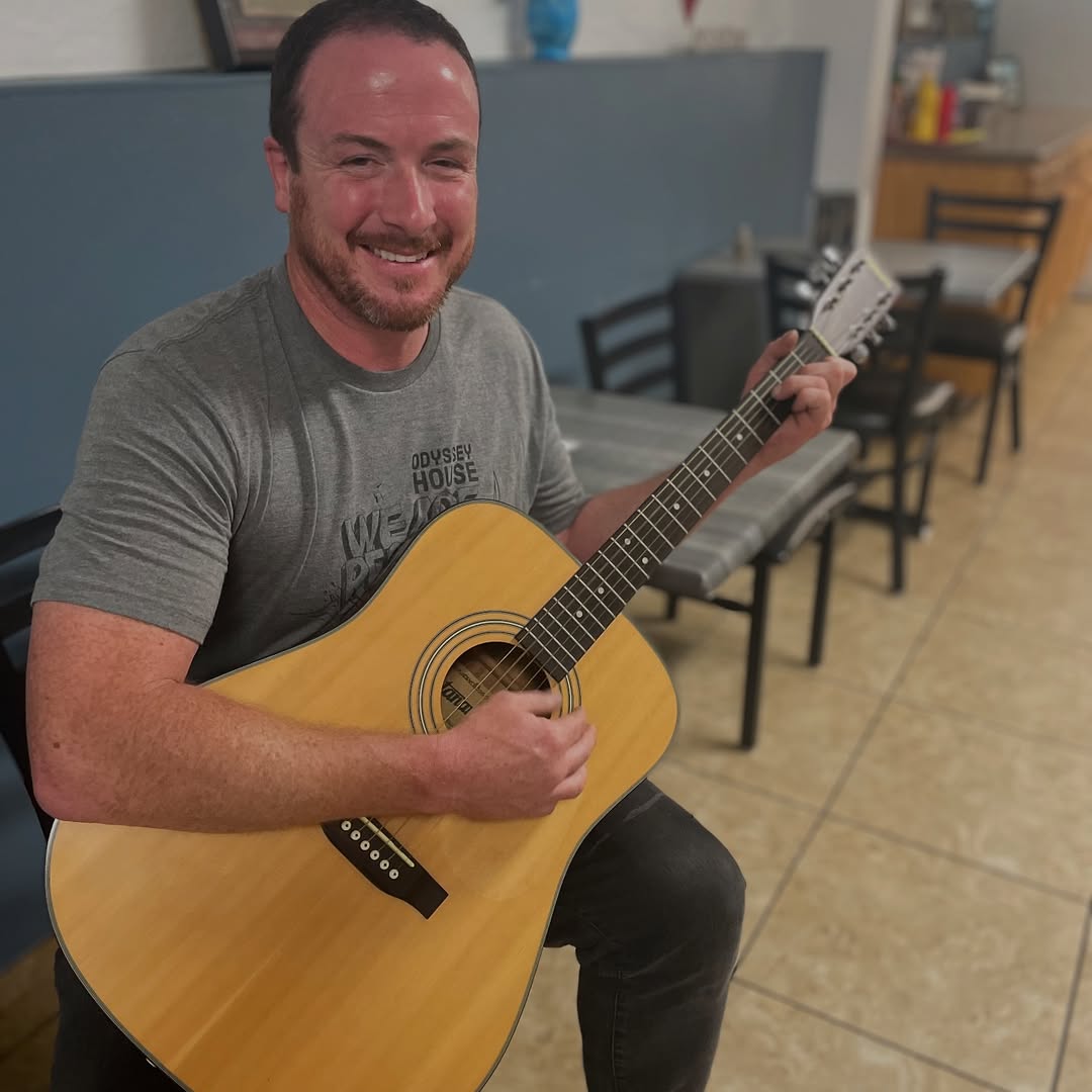 man holding a guitar