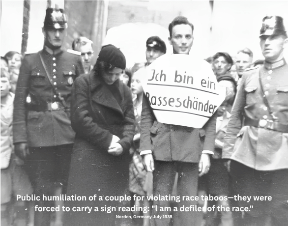 Public humiliation of a couple for violating race taboos they were forced to carry a sign reading l am a defiler of the race. Norden, Germany July 1935