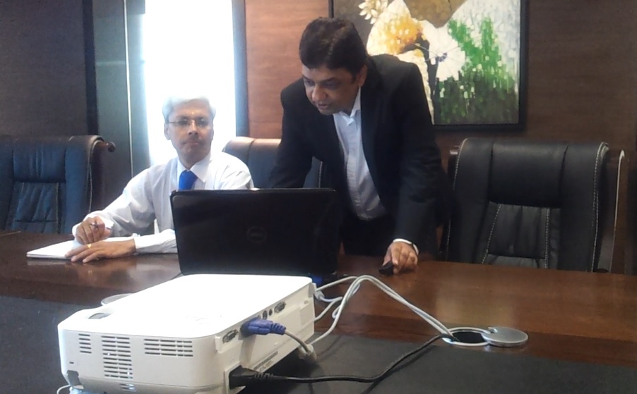 Vijay Mistri advising executive in a corporate boardroom