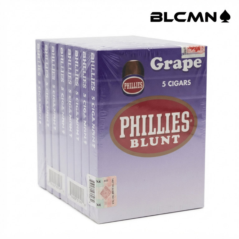 A high-resolution, studio 3D product photograph on a clean white background showcasing ten purple and white retail packs of Phillies Blunt Grape cigars arranged neatly in a row to form a full master box display under transparent cellophane wrapping. Each individual pack features the distinct red and gold Phillies Blunt logo, "Grape 5 CIGARS" text, and health warning labels. The black typography logo "BLCMN♠️" is placed in the top right corner.