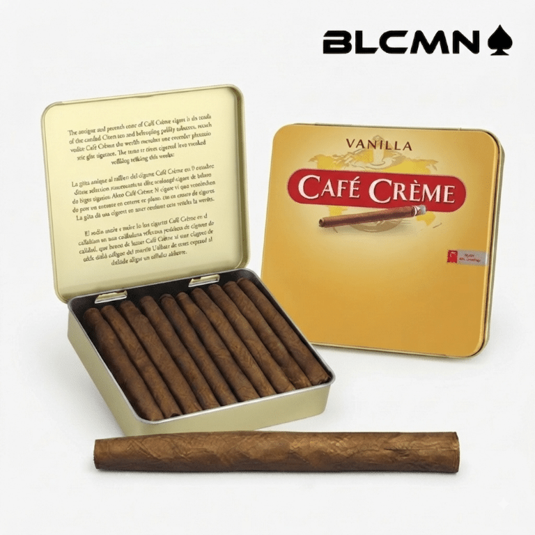 A high-resolution, studio 3D product photograph on a clean white background featuring an open gold Cafe Creme metal retail tin displaying ten miniature dry-cured cigarillos inside, alongside a single cigarillo resting in the foreground and a closed vanilla-labeled tin in the background. The black typography logo "BLCMN♠️" is placed in the top right corner.